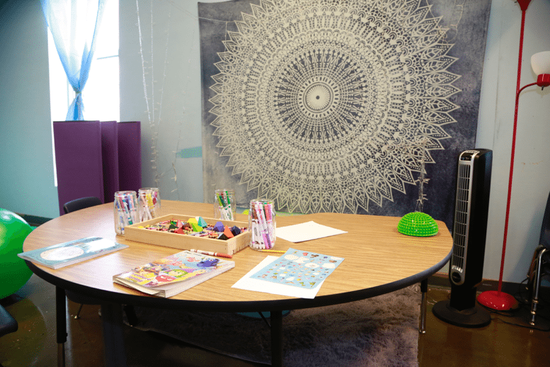 Mindfulness coloring table with books and crayons/markers.