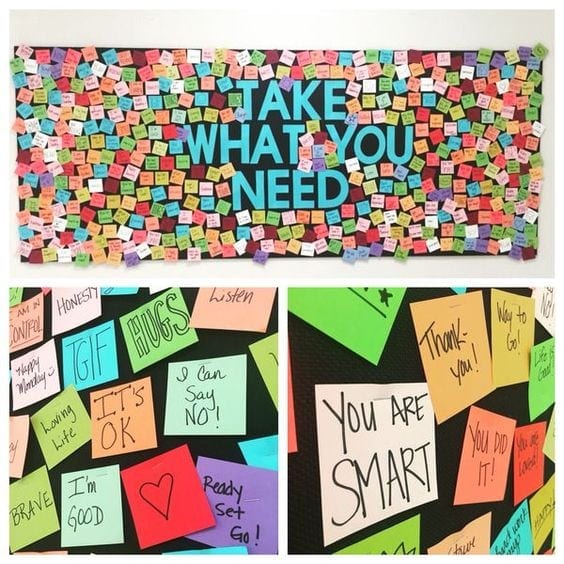 Rainbow bulletin board, "take what you need" with inspirational sticky notes
