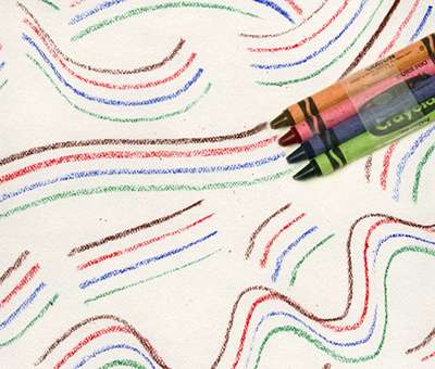Four crayons are taped together. Lines are created on paper from the taped crayons (second grade art)