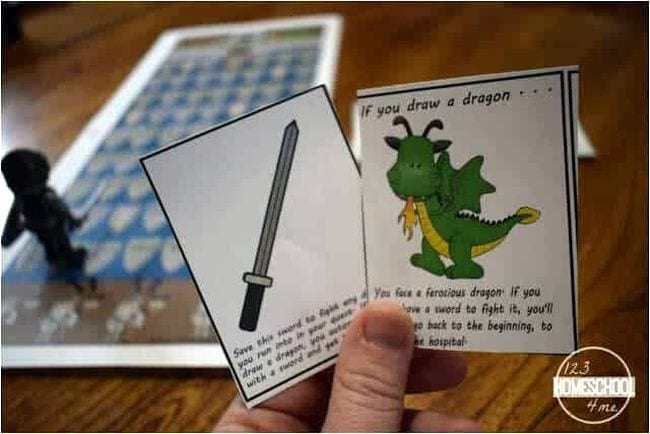 Student holding division game cards featuring a sword and a dragon (Teaching Division)