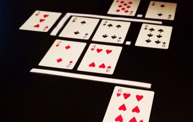 Playing cards laid out to represent a long division problem