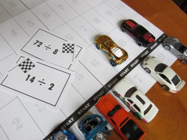Toy cars with division problem cards and game board