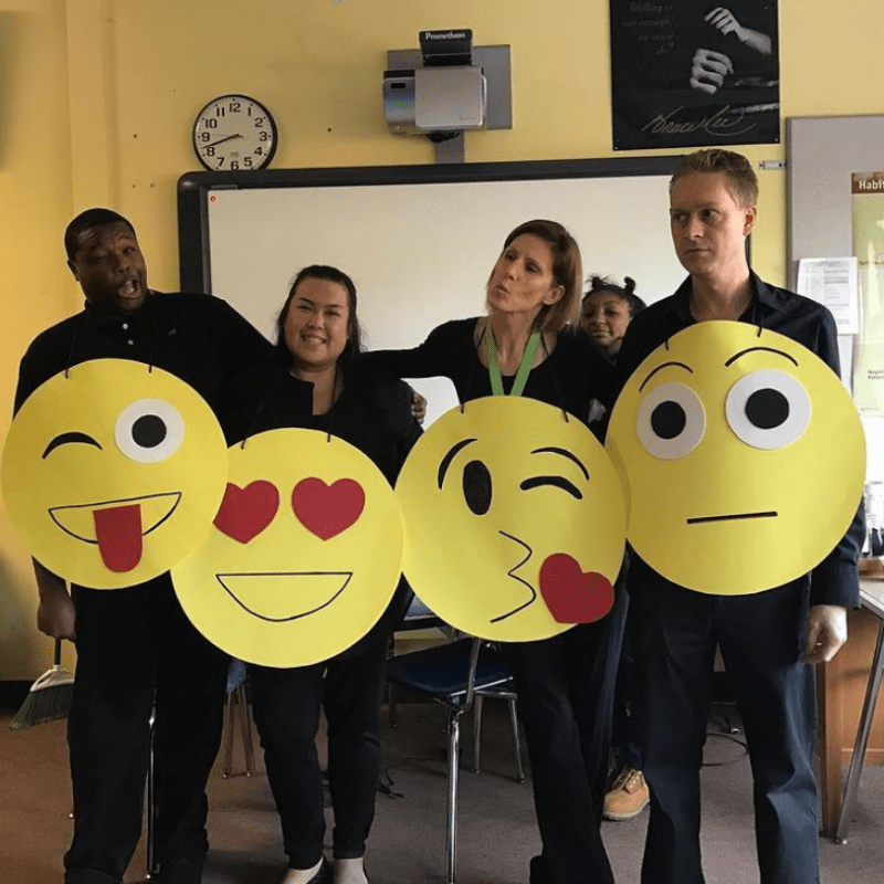 Teachers are shown dressed as different emojis.