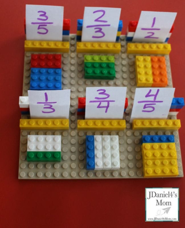 Lego bricks laid out to represent fractions with cards showing the fractions