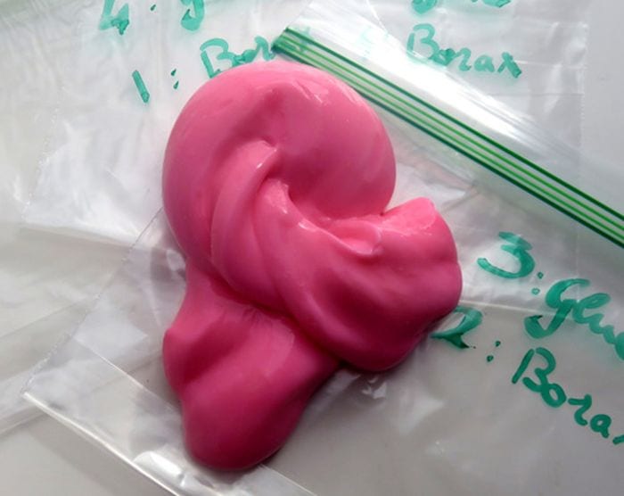 Blob of bright pink slime sitting on clear zipper bags (Third Grade Science)
