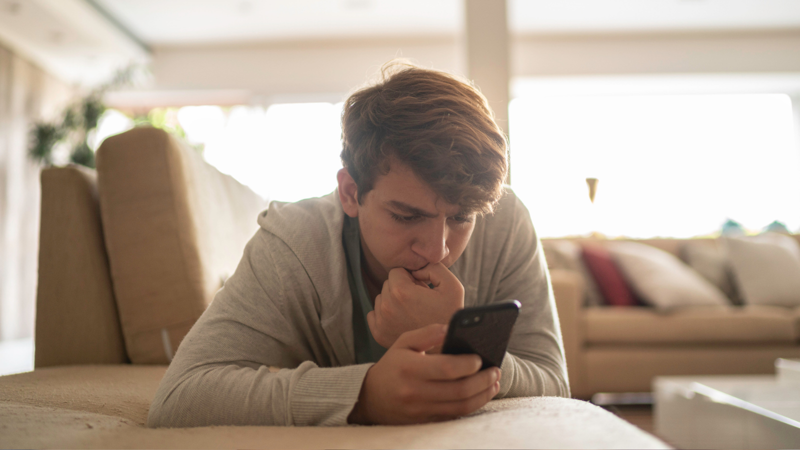 Photo of teenager texting using cell phone guidelines for tweens