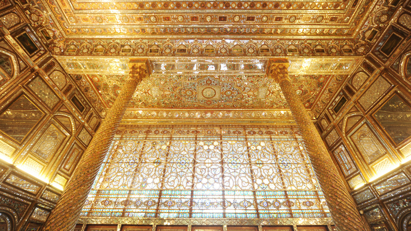 Interior of a golden palace with a opulently designed window