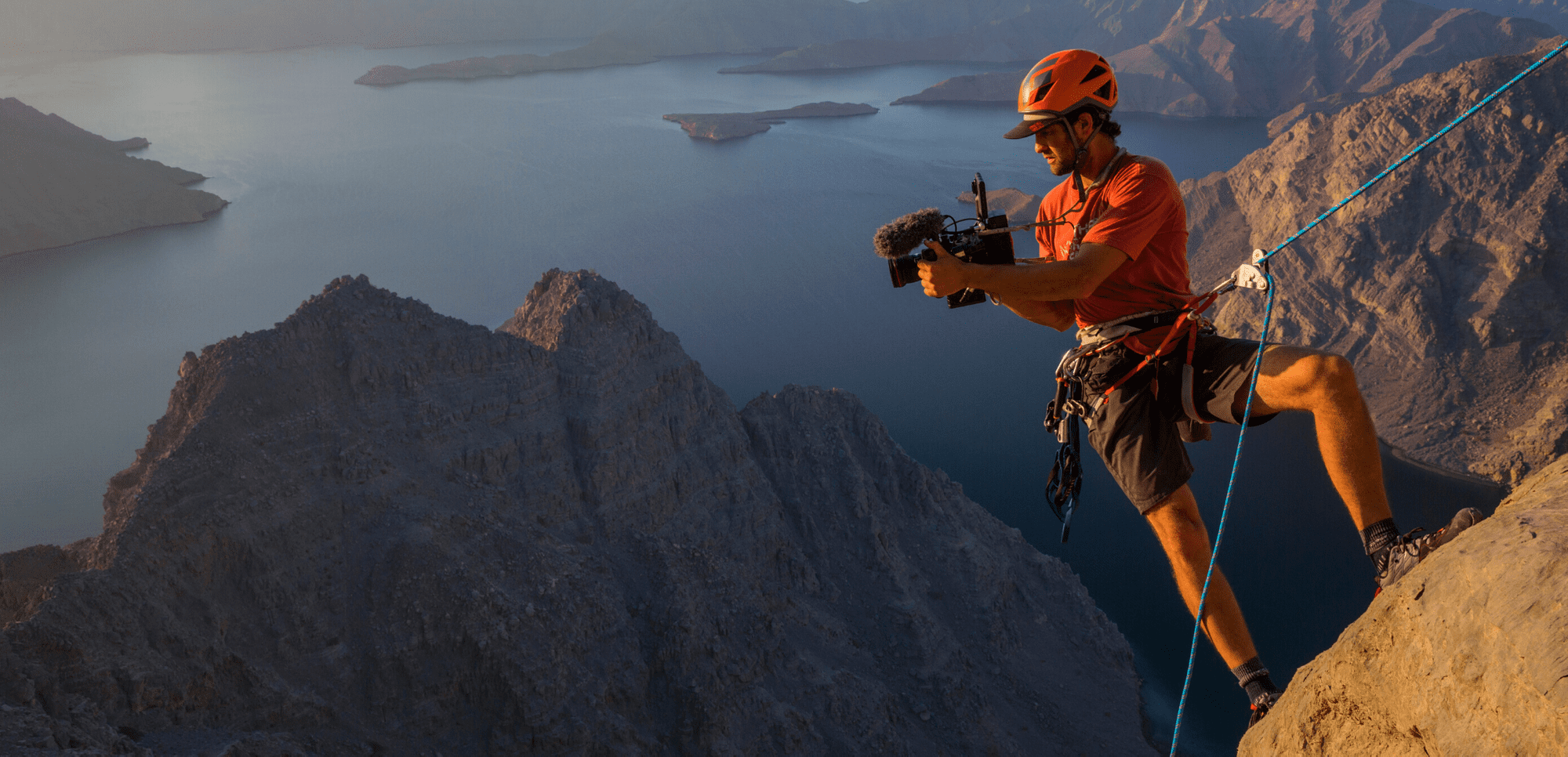 National Geographic Explorer rock climbing with a video camera