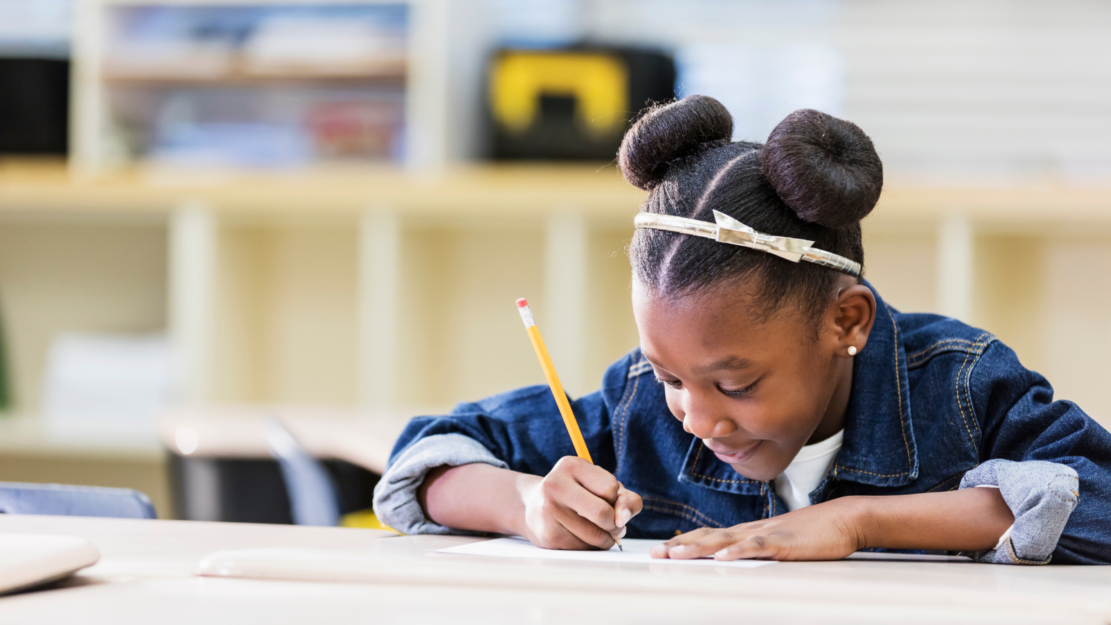 25 Meaningful Presidents’ Day Activities for the Classroom Image of a young Black female student writing a letter to the President.