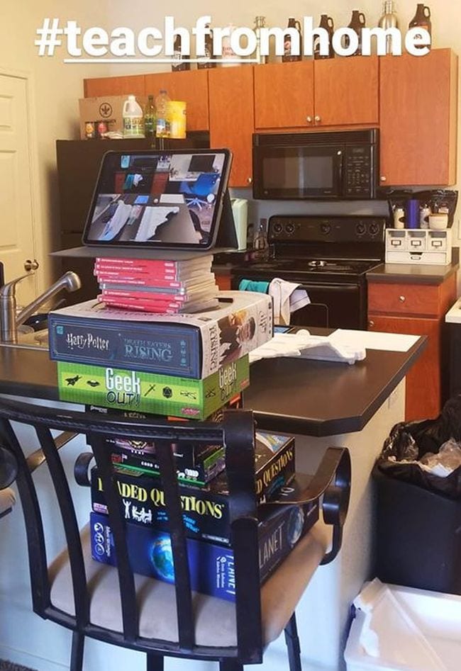 Laptop propped up on Harry Potter books in kitchen to teach from home