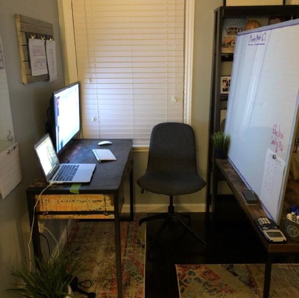 Virtual classroom with whiteboard, desk, laptop and computer screen in living room