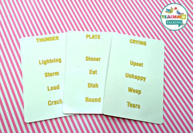 Vocabulary cards with synonyms on a pink-striped background