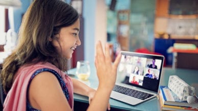 Schoolgirl is e-learning and video conferencing at home.