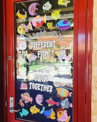 we might all be different fish but in this class we like to swim together. swimming fish under the sea classroom door decorations