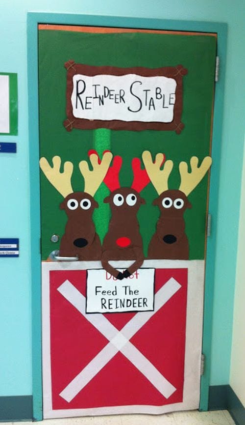 A door is decorated to look like a reindeer stable.