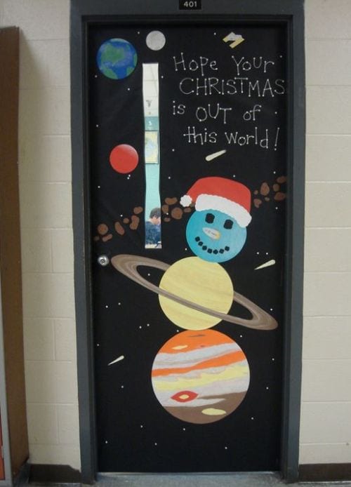 Classroom door decorated with a snowman made out of planets, with text reading Hope Your Christmas Is Out of This World!