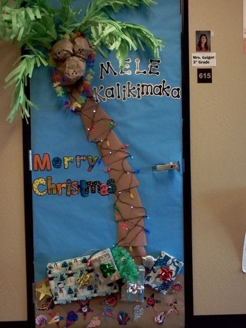 A winter themed door is decorated with a palm tree.
