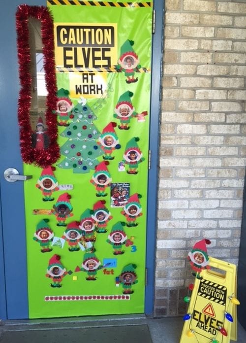 A door says Caution Elves at Play and has elves with the students in the class's face on them.