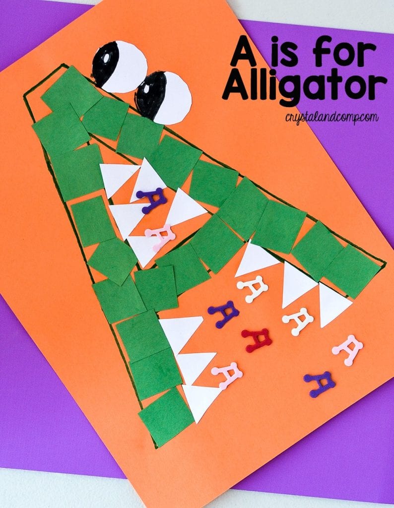 An orange piece of construction paper with a green capital letter A decorated to look like an alligator as an example of alphabet activities