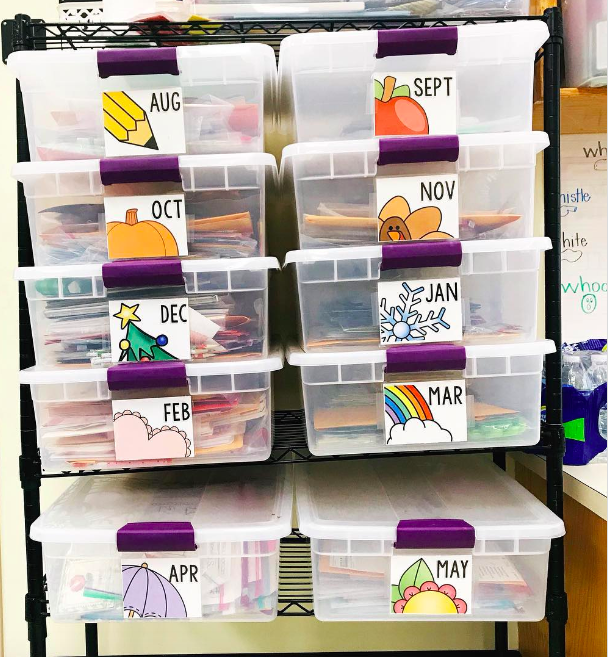 Stacked bins of classroom supplies labeled with the months of the year
