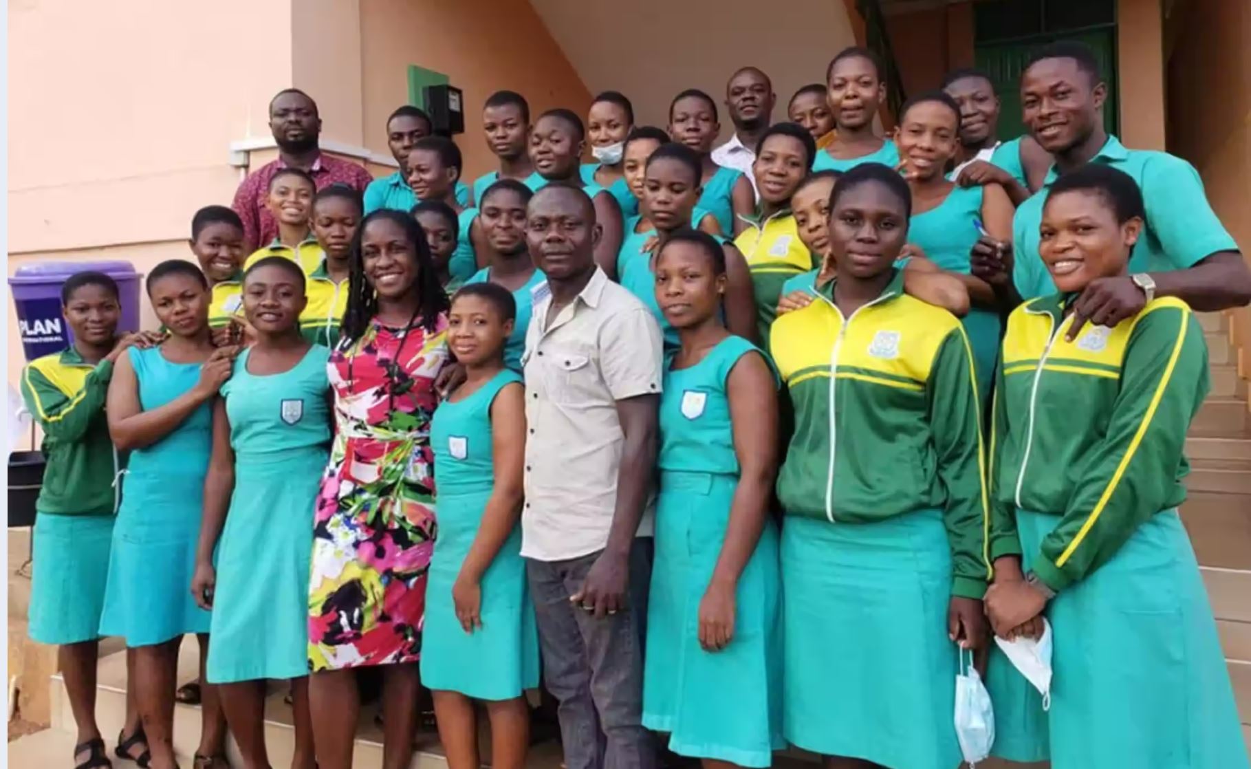 Group of students standing with English teacher who is teaching abroad, as an example of summer professional development for teachers