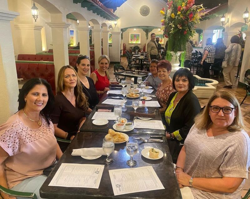 A group of school administrative professionals having lunch in a restaurant