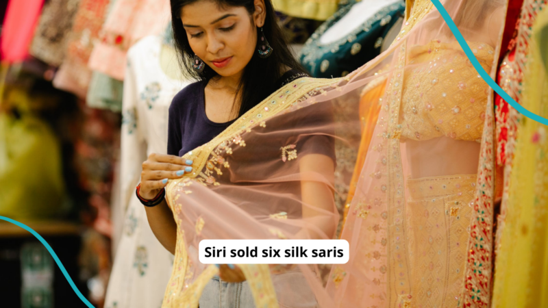 A woman holding up a sari in a shop. Text is an alliteration example: Siri sold six silk saris.