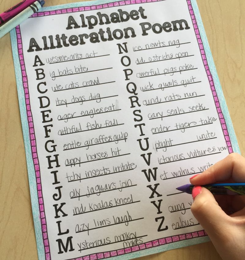 Student writing on an Alphabet Alliteration Poem with an alliterative phrase about animals for each letter of the alphabet