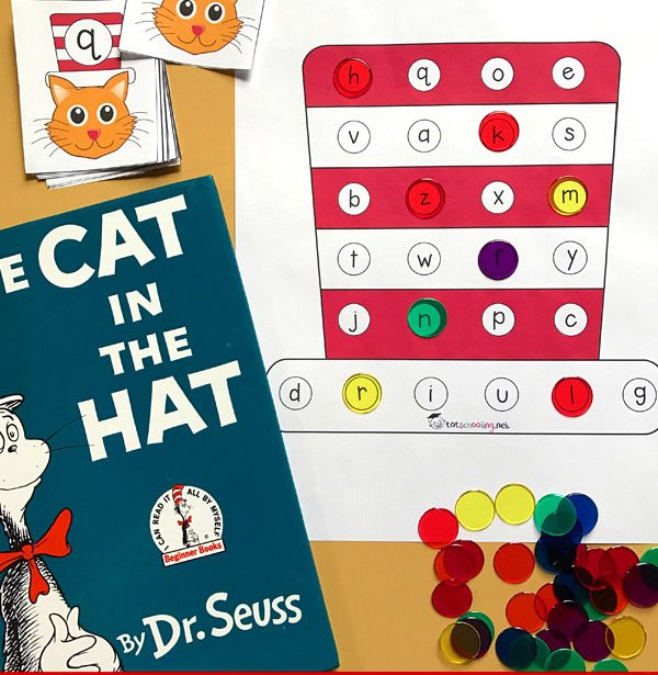 Cat in the Hat book in the foreground. Worksheet with red and white striped hat with letters in circles and colored plastic discs on top in the background