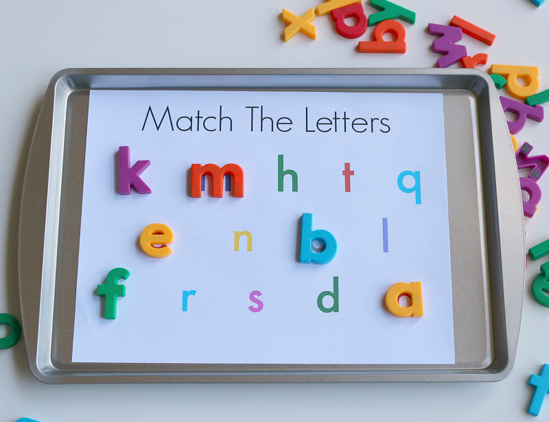 cookie tray with letter paper and magnetic letters on it for a preschool activity