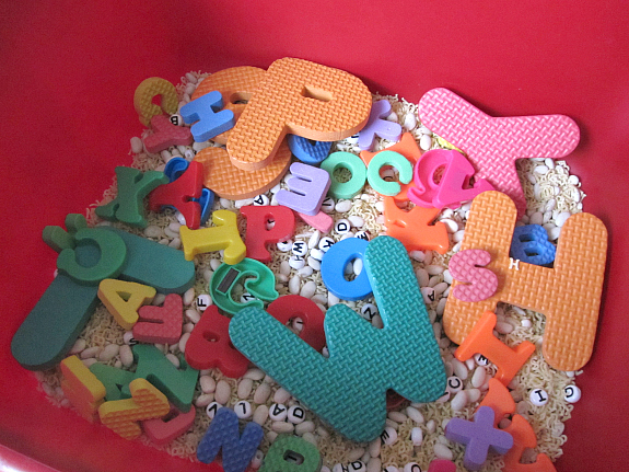 bin of dried beans with letters in it for preschool activity