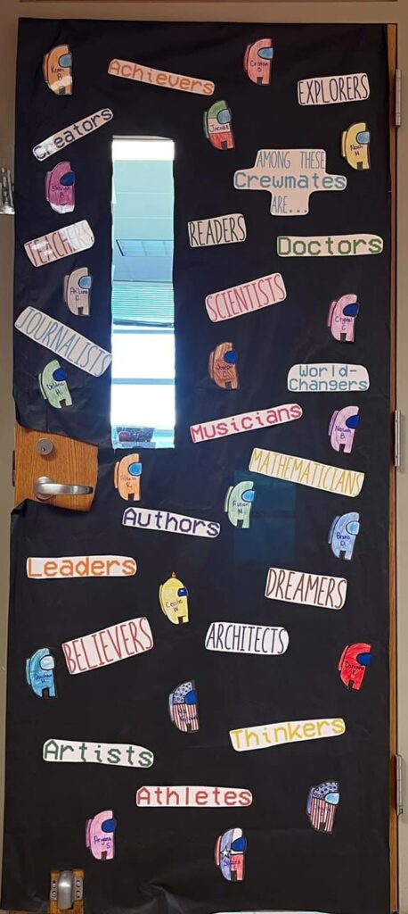 Classroom door decorated with Among Us characters and words like authors, believers, dreamers, etc.