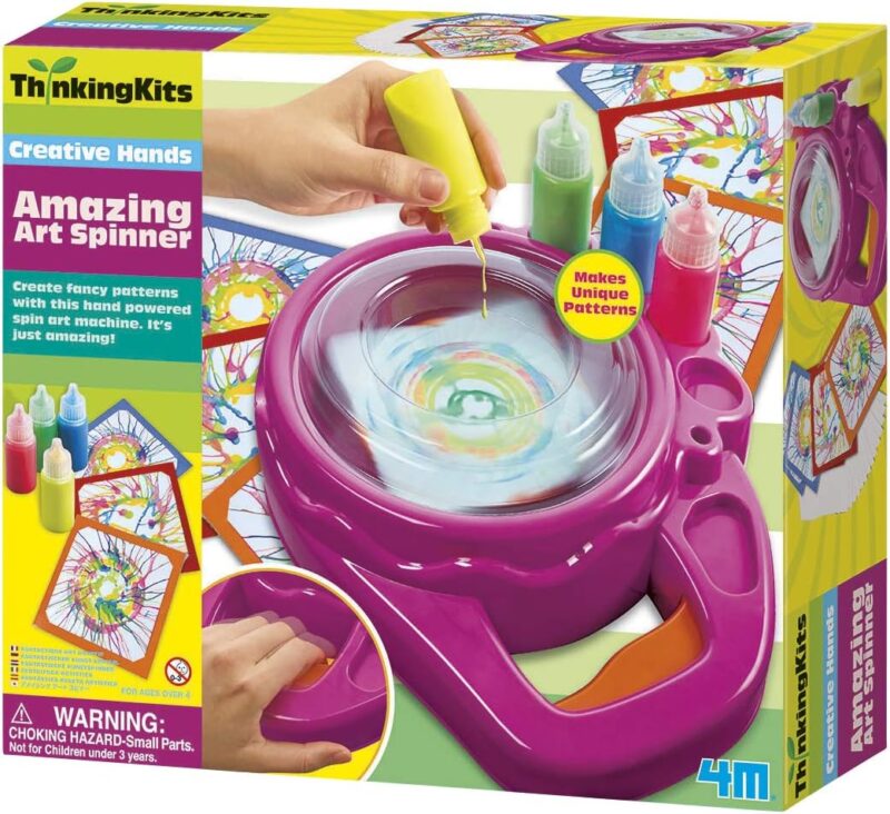 Art gifts for kids include this art spinner. A hand is shown dropping paint onto a purple device that spins.