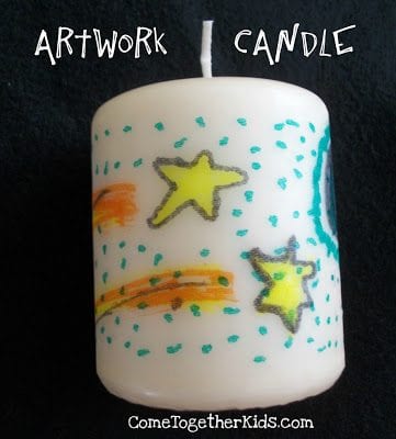 Candle painted with stars and dots.
