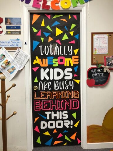 totally awesome kids are busy learning behind this door. classroom door colorful shapes