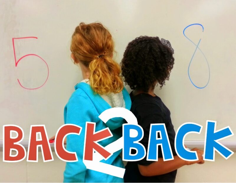 students standing back to back writing numbers on a board