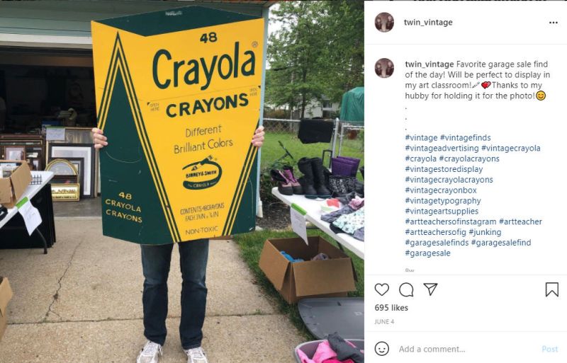 Instagram page showing teacher holding up large Crayola crayon box sign