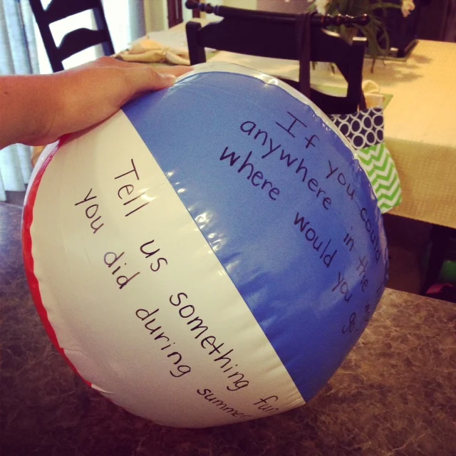 beach ball with questions written on it to use with active ice breakers 