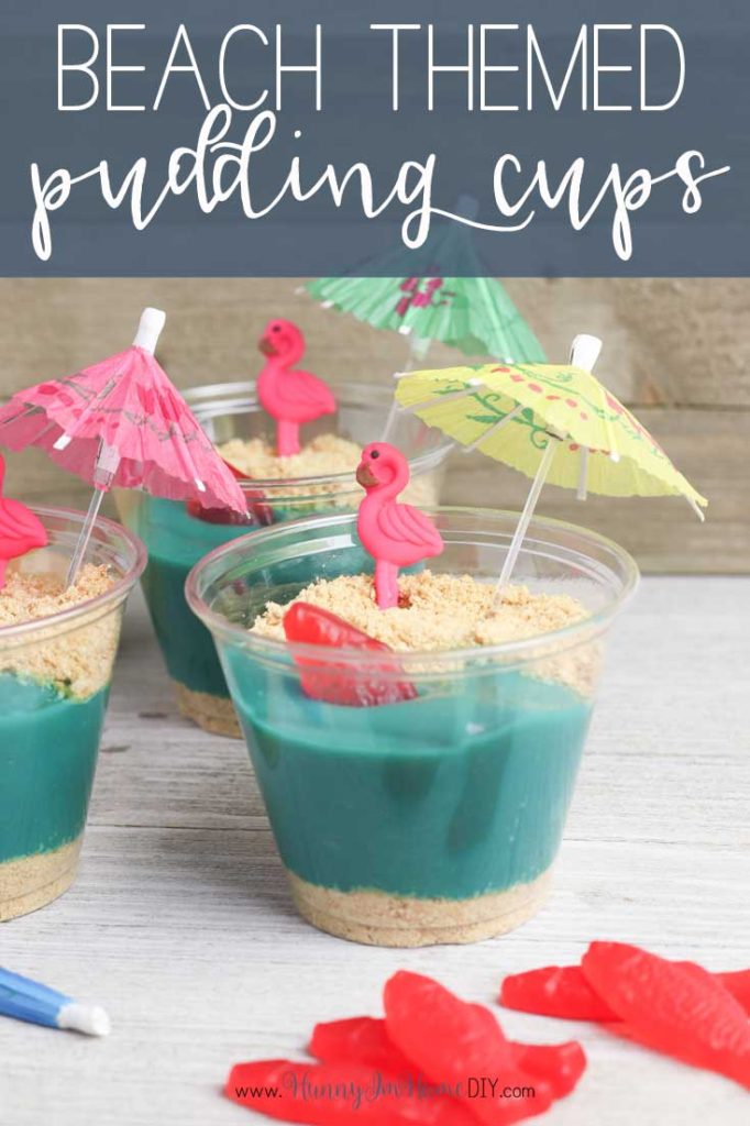 Little cups are filled with blue pudding and graham cracker crumbs. They have flamingos and little umbrellas in them. 
