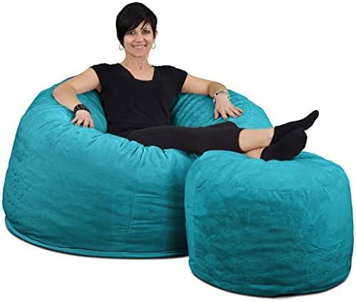 A woman sits on an oversized teal beanbag chair with a matching footrest.