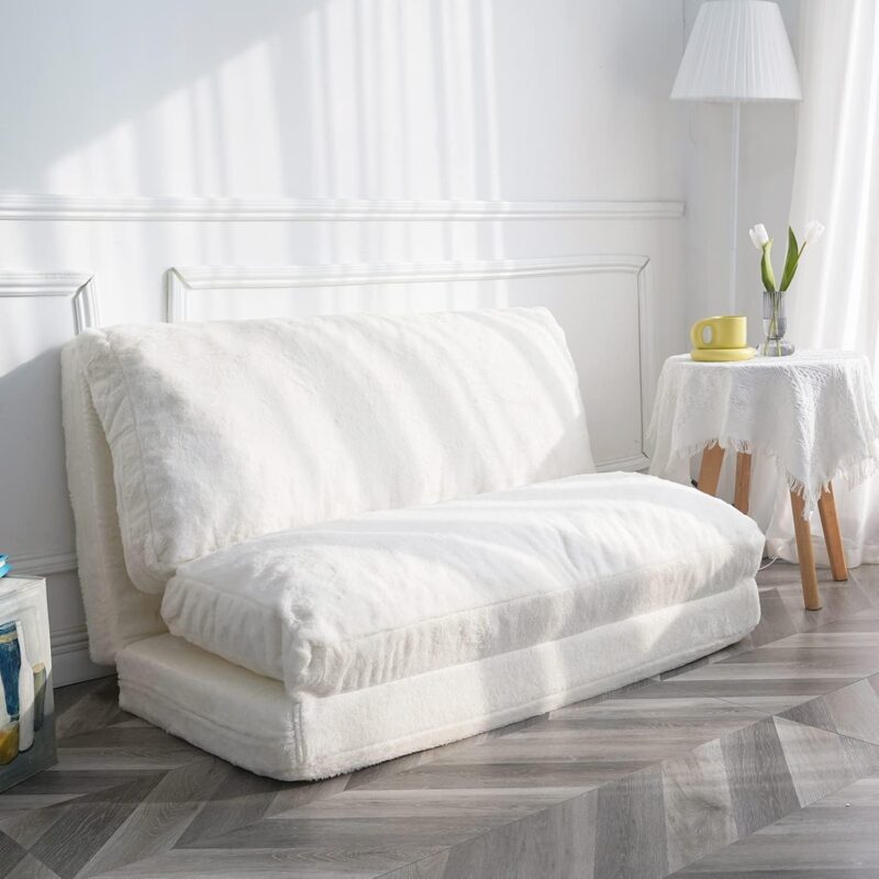 A large sofa is made from cream colored fur. It is low to the ground and the cushion is a beanbag.