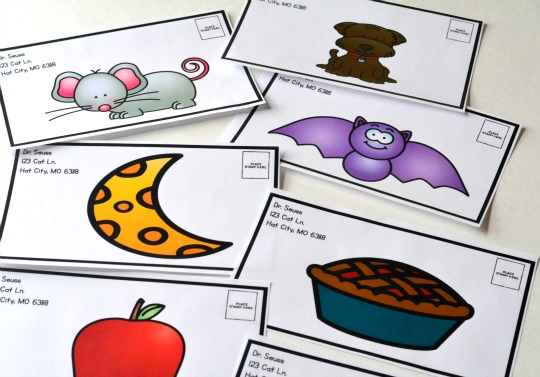 pictures of items like the moon, a bat, and a mouse on the covers of pretend letters ready to be sent, as an example of reading activities