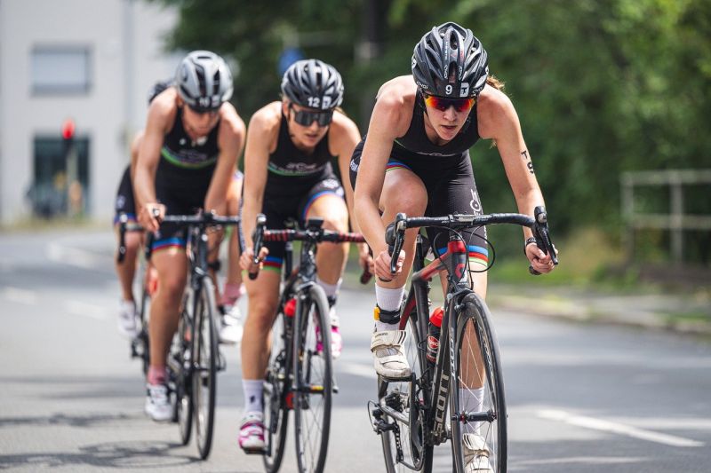 Three people competing in a bicycle race