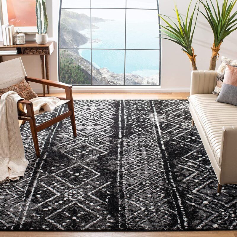 A patterned rug is black and silver.
