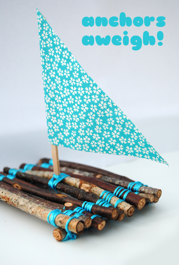 A simple raft made from twigs laced together with a triangular fabric sail