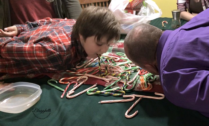 two people bobbing for candy canes for a candy cane game