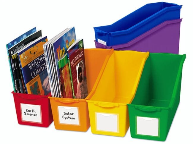 Rainbow colored book bins with white labels on the front