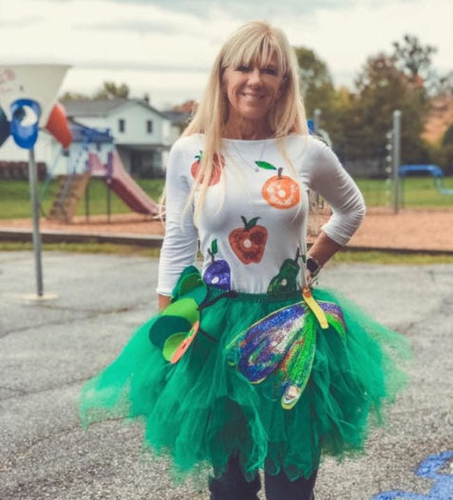 Woman wearing a green tutu and white shirt covered with pictures of food (Book Character Costume Ideas)