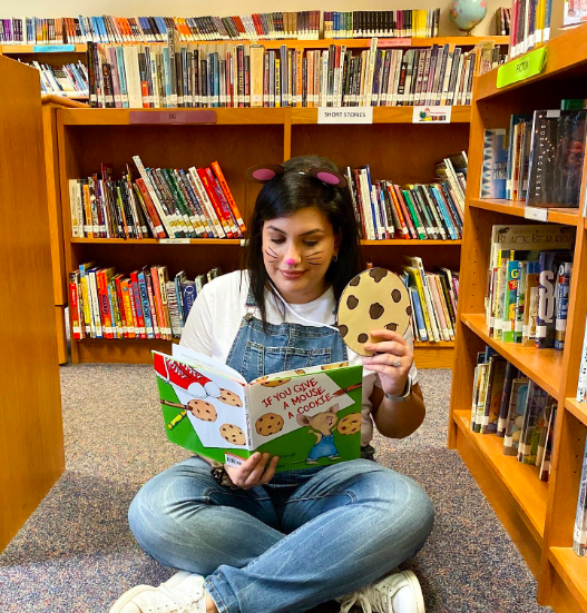 A teacher dressed up as the main character from If You Give a Mouse a Cookie as an example of Read Across America activities