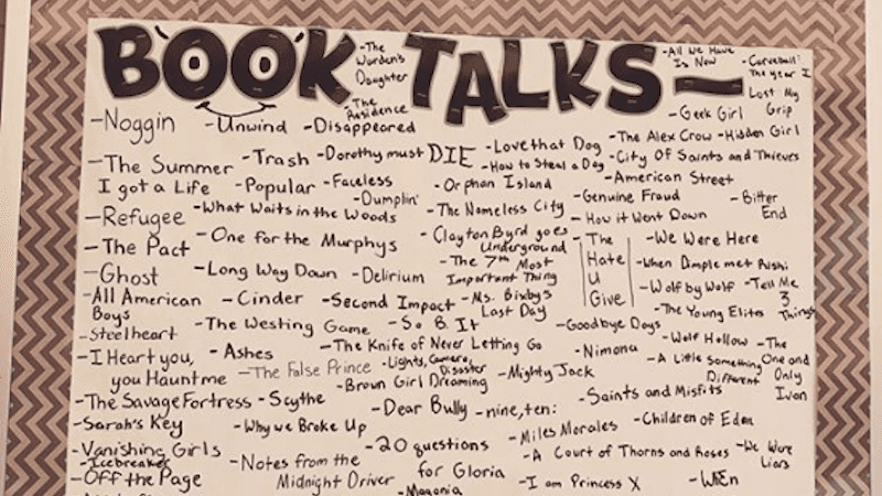 bulletin board with book talks written on it and lists of books 